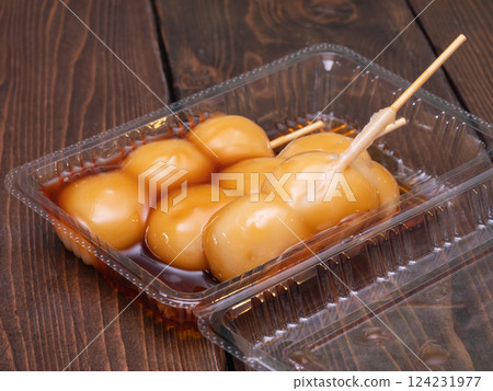 Japanese sweets in a plastic container. "Mitarashi dango" with sweet soy sauce sauce. Japanese sweets in a plastic container. "Mitarashi dango" with sweet soy sauce sauce. 124231977
