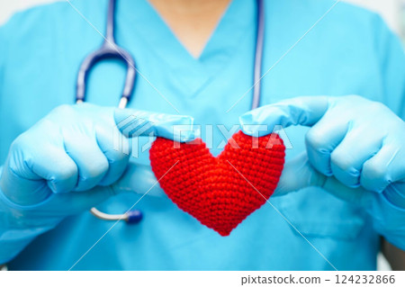 Asian woman doctor holding red heart for health in hospital. Asian woman doctor holding red heart for health in hospital. 124232866