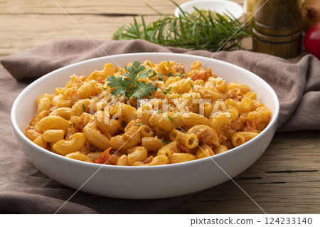 Stir fried macaroni with tomatoes sauce cheese and mince pork on white plate 124233140