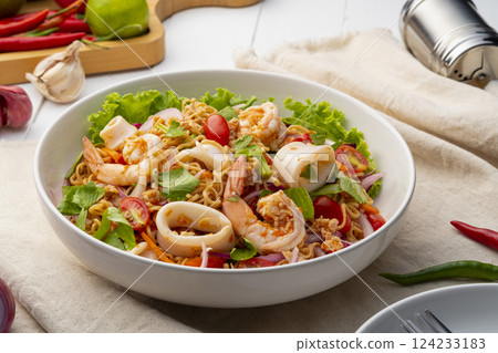 instant noodle spicy salad.Thai hot and sour noodle salad with squid shrimp and minced pork that is very flavorful and addictive 124233183