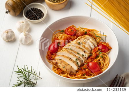 Grilled chicken breast with spaghetti tomato sauce in white plate Grilled chicken breast with spaghetti tomato sauce in white plate 124233189