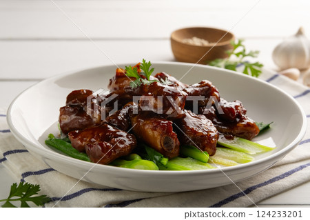 Close up Honey Braised Pork Baby Back Ribs or pork cartilage with soy sauce in white plate. Close up Honey Braised Pork Baby Back Ribs or pork cartilage with soy sauce in white plate. 124233201