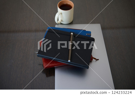 Organized Desk with Notebook, Pen, and Coffee on Wooden Surface 124233224