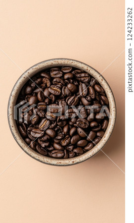 Fresh Roasted Coffee Beans in Earthy Bowl Against Soft Background Fresh Roasted Coffee Beans in Earthy Bowl Against Soft Background 124233262