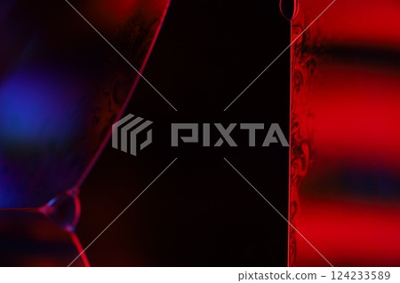 Red and purple fluid reflections on black background, liquid surface abstraction, colour edge, deep dark backgrounds, geometric water shapes, fluids movement, phenomenal physical features 124233589
