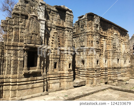 Ancient hindu temple in Kangra fort, Himachal Pradesh, India. Ruins with intricate stone carvings in a historical site. 124233679