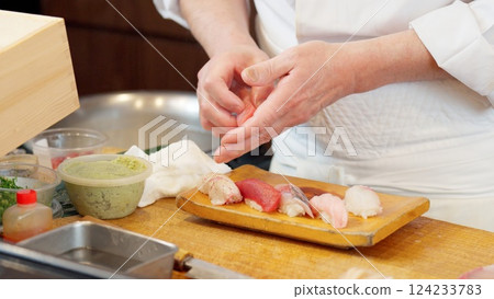 The hands of a chef preparing sushi 124233783