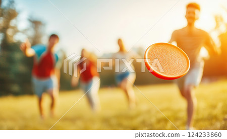 Playing frisbee in sunny park, group of friends enjoys fun day outdoors. vibrant atmosphere captures joy of friendship and active leisure 124233860