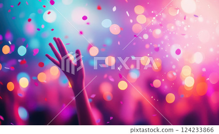 Colorful lights and confetti create vibrant atmosphere as hands reach up joyfully, celebrating lively event filled with excitement and energy 124233866