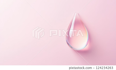 clear water droplet reflecting soft colors on pink background 124234263