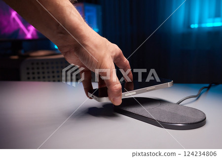 smartphone wireless charging on induction charger. Wireless charger 124234806