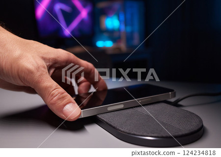 smartphone wireless charging on induction charger. Wireless charger smartphone wireless charging on induction charger. Wireless charger 124234818