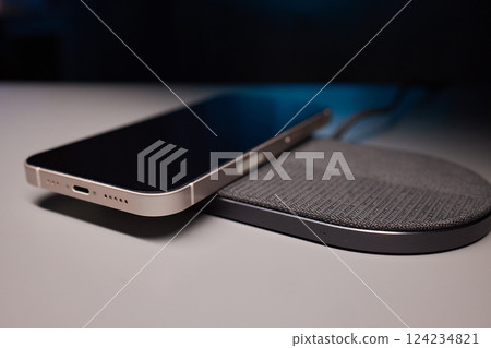 smartphone wireless charging on induction charger. Wireless charger 124234821