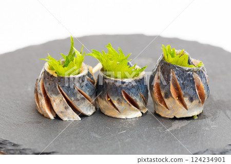 Sardine rolls: Stock photo of sardines wrapped in shiso leaves and pierced with toothpicks Sardine rolls: Stock photo of sardines wrapped in shiso leaves and pierced with toothpicks 124234901