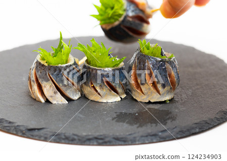 Sardine rolls: Stock photo of sardines wrapped in shiso leaves and pierced with toothpicks Sardine rolls: Stock photo of sardines wrapped in shiso leaves and pierced with toothpicks 124234903