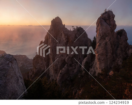 Golden hour photography on a foggy cliff. Solar wind. 124234919