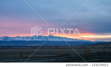 Distant view of high snowy mountains at dusk 124234921