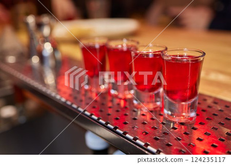 Bartender pouring and serving alcoholic drinks at bar Bartender pouring and serving alcoholic drinks at bar 124235117