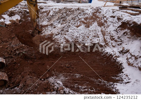 excavator transferring a ground with a heavy bucket into the back side of the truck. excavator transferring a ground with a heavy bucket into the back side of the truck. 124235212