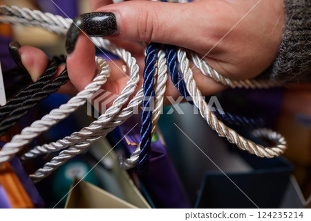 An Array of Colorful Twisted Ropes Displayed in Hand, Perfect for Various Uses and Crafts An Array of Colorful Twisted Ropes Displayed in Hand, Perfect for Various Uses and Crafts 124235214