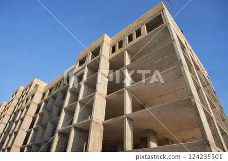 It is view of a new incomplete house without tiles on roof in sunny summer day. It is a close up view of modern house without roof. It is close up view of unfinished building apartment It is view of a new incomplete house without tiles on roof in sunny summer day. It is a close up view of modern house without roof. It is close up view of unfinished building apartment 124235501