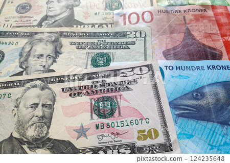 Stack of US Dollar and Norwegian krone 124235648