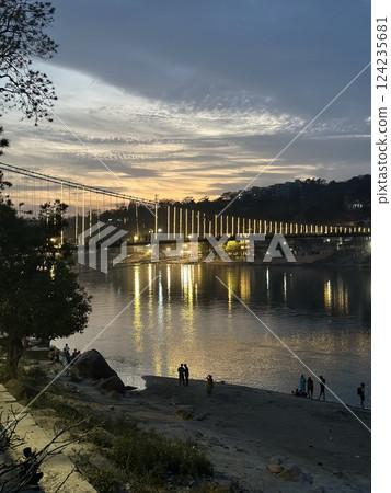Sunset over Ram Jhula bridge in Rishikesh, India. Sunset over Ram Jhula bridge in Rishikesh, India. 124235681