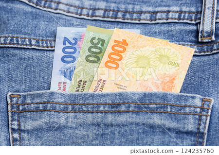 Argentine peso in the pocket of blue jeans Argentine peso in the pocket of blue jeans 124235760
