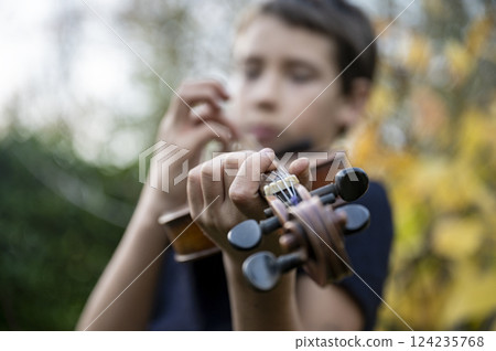 Young musician playing the violin Young musician playing the violin 124235768