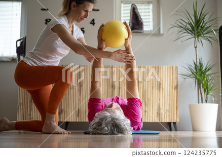 Assisted fitness training with a medicine ball 124235775