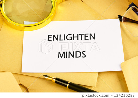 A collection of educational stationery featuring a card saying enlighten minds alongside envelopes and glasses A collection of educational stationery featuring a card saying enlighten minds alongside envelopes and glasses 124236282