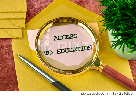 A magnifying glass highlights the phrase Access to Education on a desk surrounded by stationery, emphasizing educational opportunities in business A magnifying glass highlights the phrase Access to Education on a desk surrounded by stationery, emphasizing educational opportunities in business 124236296