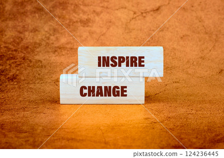 Wooden blocks display the words inspire and change, connecting themes of education, business, and the importance of transformation Wooden blocks display the words inspire and change, connecting themes of education, business, and the importance of transformation 124236445