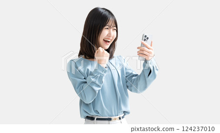 A woman/businesswoman happy to see her smartphone 124237010