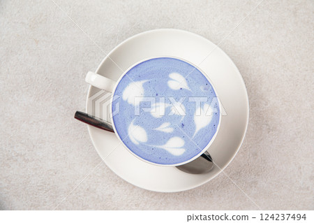 Portion of blue matcha latte in white cup 124237494