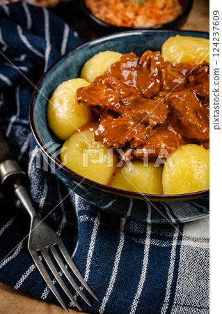 Beef stew in gravy, served with silesian dumplings. 124237609