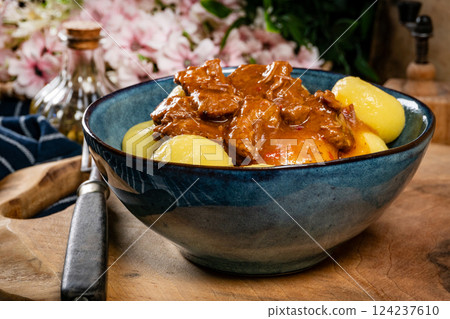 Beef stew in gravy, served with silesian dumplings. 124237610