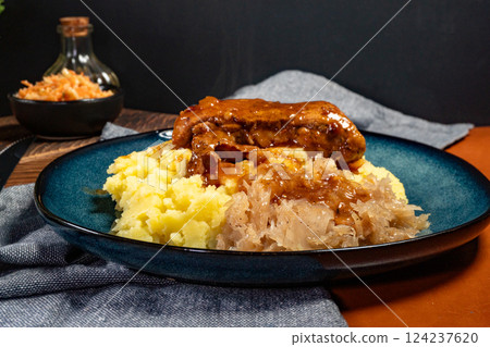 Braised pork ribs with spicy sauce served with mashed potatoes and sauerkraut. Braised pork ribs with spicy sauce served with mashed potatoes and sauerkraut. 124237620