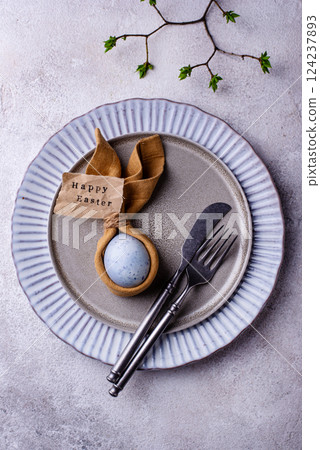 Elegant Easter table setting with painted egg Elegant Easter table setting with painted egg 124237893
