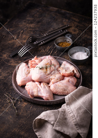 Raw chicken wings on black background. 124237938