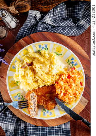 Minced chicken cutlet served with mashed potatoes and salad. 124238001