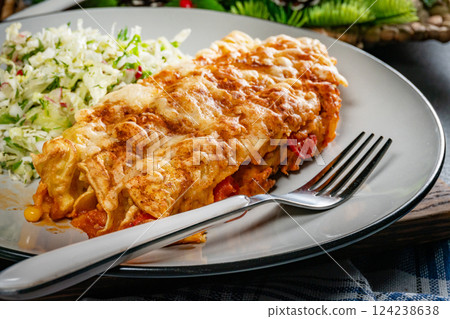 Stuffed pancake baked with cheese. 124238638