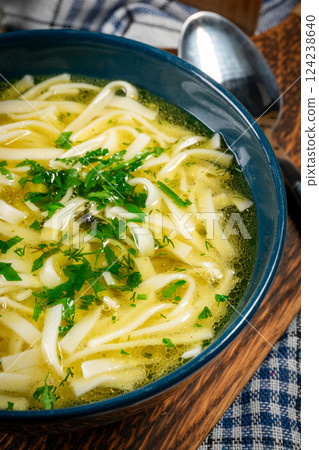 Broth - chicken soup in a bowl. 124238640