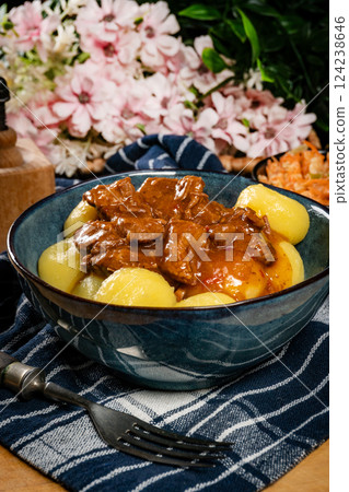 Beef stew in gravy, served with silesian dumplings. Beef stew in gravy, served with silesian dumplings. 124238646