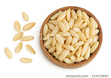 Shelled European pine nuts in wooden bowl isolated on white background with full depth of field. Top view. Flat lay Shelled European pine nuts in wooden bowl isolated on white background with full depth of field. Top view. Flat lay 124238684