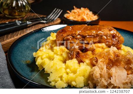 Braised pork ribs with spicy sauce served with mashed potatoes and sauerkraut. Braised pork ribs with spicy sauce served with mashed potatoes and sauerkraut. 124238707