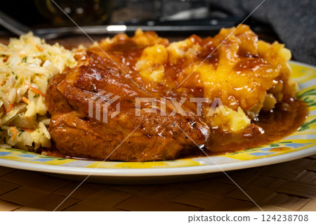 Braised pork ribs with spicy sauce served with mashed potatoes and salad. 124238708