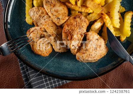 French fries with chicken pieces. French fries with chicken pieces. 124238761