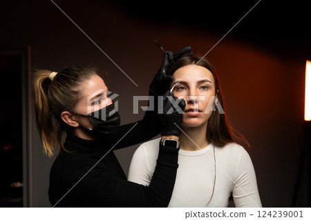 An engaging eyebrow styling session showcasing precision and artistry through innovative techniques 124239001