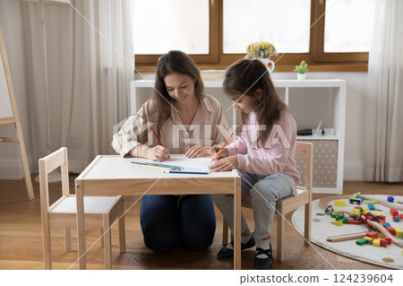 Happy young mother draw colorful pictures with little daughter Happy young mother draw colorful pictures with little daughter 124239604
